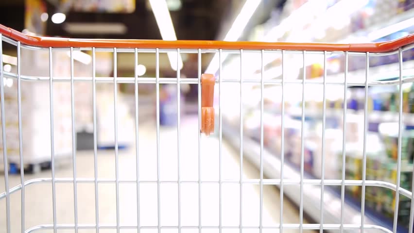 a shopping cart is moving slowly through a market