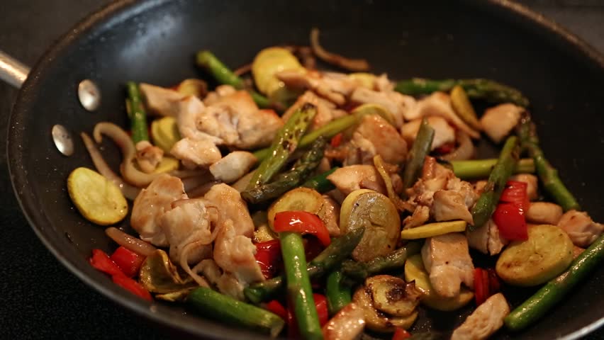 cooking chicken and vegetable stir fry 
