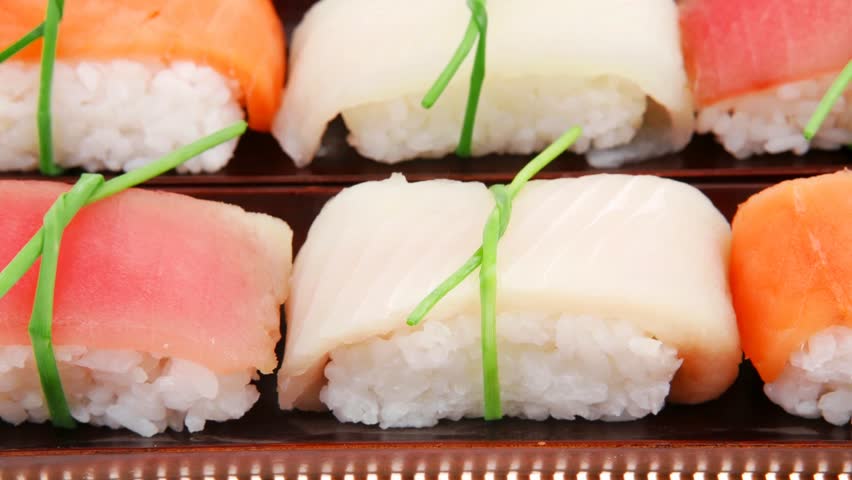 Japanese traditional cuisine - Different Types of Nigiri Sushi : Tuna (maguro) Salmon (sake) and Eel (unagi) with Wasabi and Ginger on bamboo mat 1920x1080 intro motion slow hidef hd