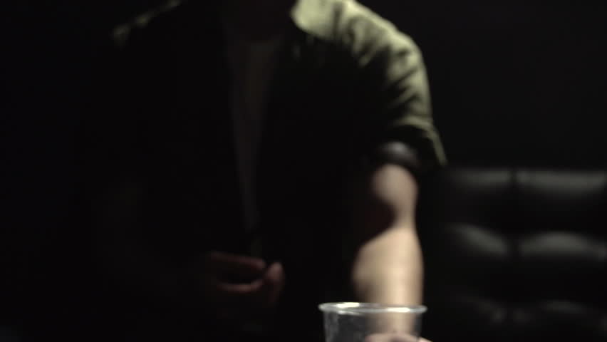 Man falls onto couch after heroin use in slow motion