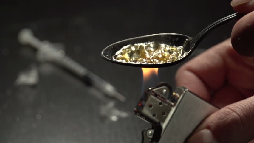 Close up of man cooking heroin
