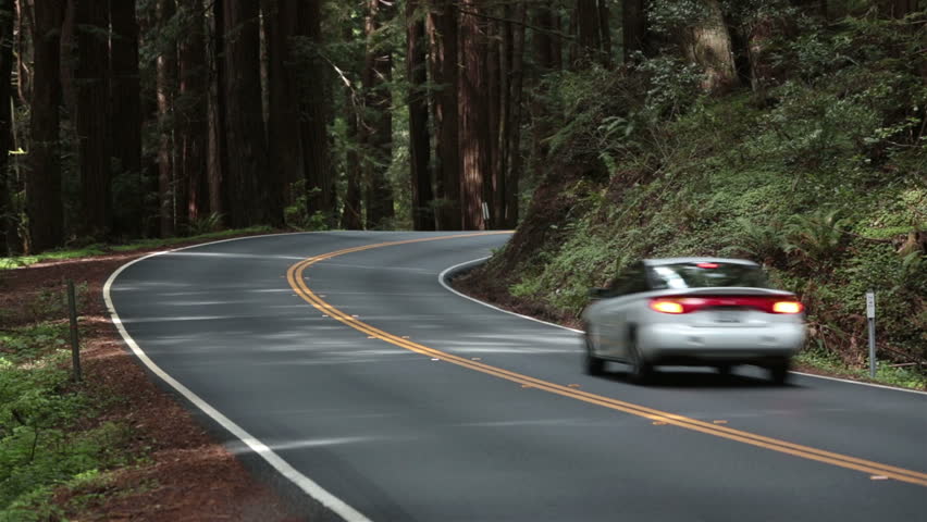 Beautiful redwood forest traffic around corner. Sequoia National Park Sierra Nevada mountains California.  Established 1890. The park spans 404,063 acres. The park is famous for giant sequoia trees.
