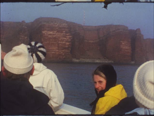 HELGOLAND, GERMANY - CIRCA 1970s: Group of people on boat take trip to Helgoland, Germany circa 1970s. Vintage 8mm film.