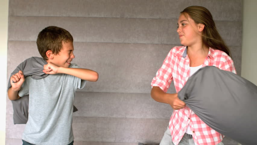 Siblings having a pillow fight in slow motion at 500 frames per second