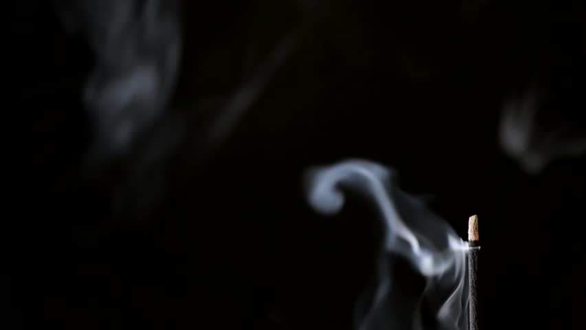Incense Stick with Smoke on Black Background