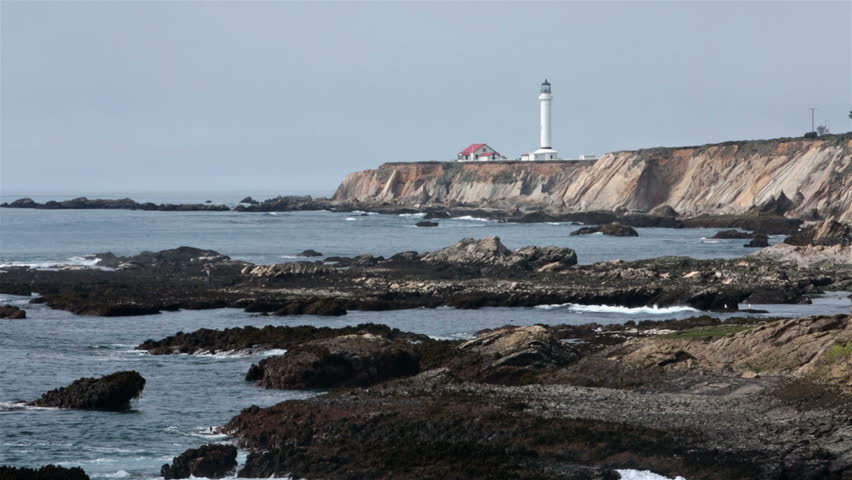 Pacific Ocean cove rocky coast Point Arean Lighthouse. Rough ocean waves and surf at Point Arena Lighthouse California. Coastal California ocean beach, cliff and beautiful scenery along highway 1. 