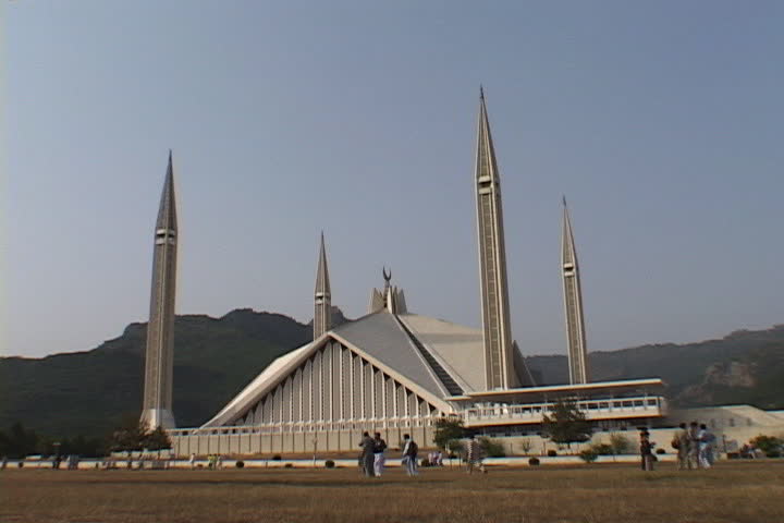 ISLAMABAD, PAKISTAN - CIRCA JUNE 1990: Faisal Mosque, with tall penci-like minarets and Margalla Hills in the background.