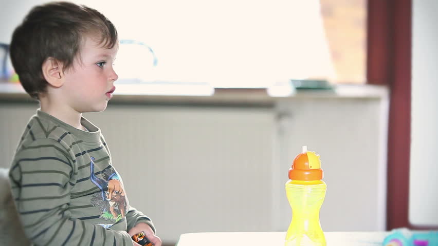 Side view of little boy watching TV
