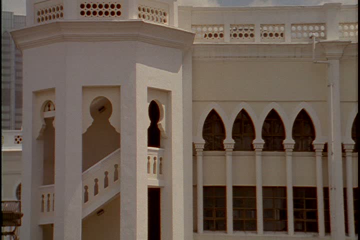 KUALA LUMPUR - CIRCA OCTOBER 1999: MS exterior stairway of railway station. Camera tilts up to onion dome surrounded by small minarets atop building.
