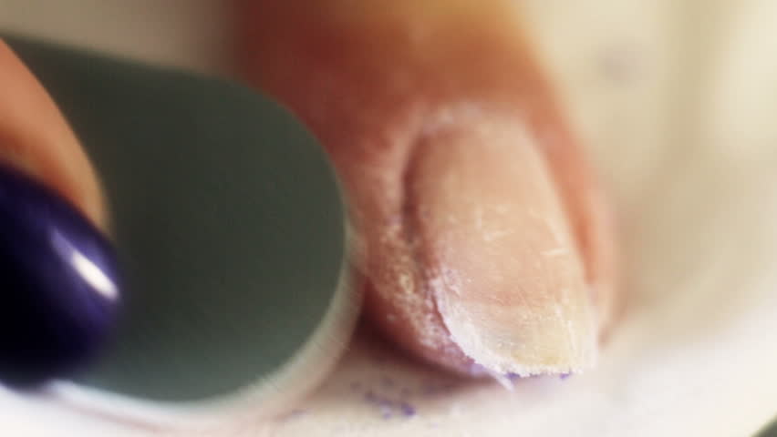 Woman removing the gel like nail polish, after it was soften by gel remover in other related stock video.