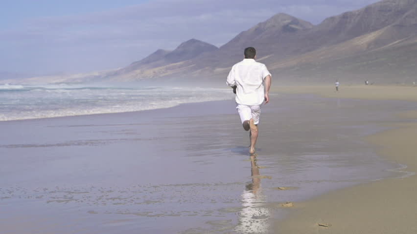 Man running on beautiful beach, super slow motion, shot at 240fps
