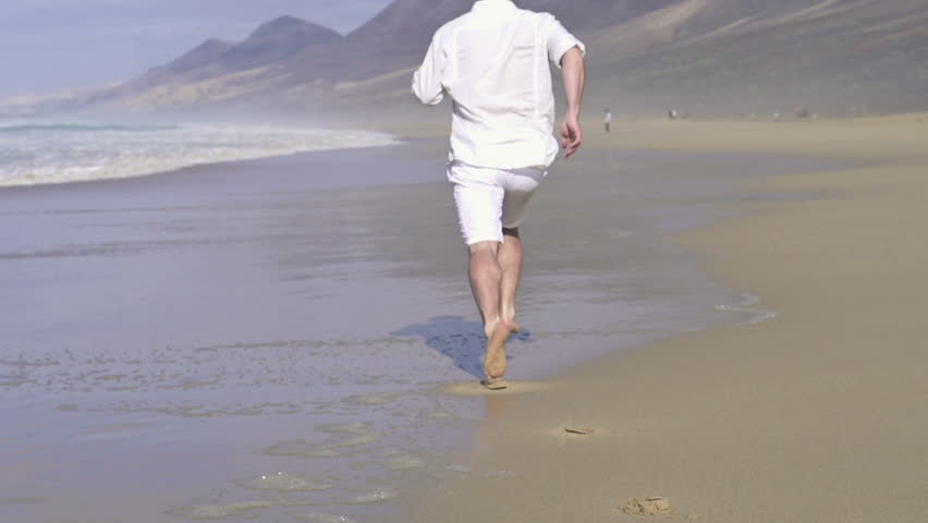 Man running on beautiful beach, super slow motion, shot at 240fps
