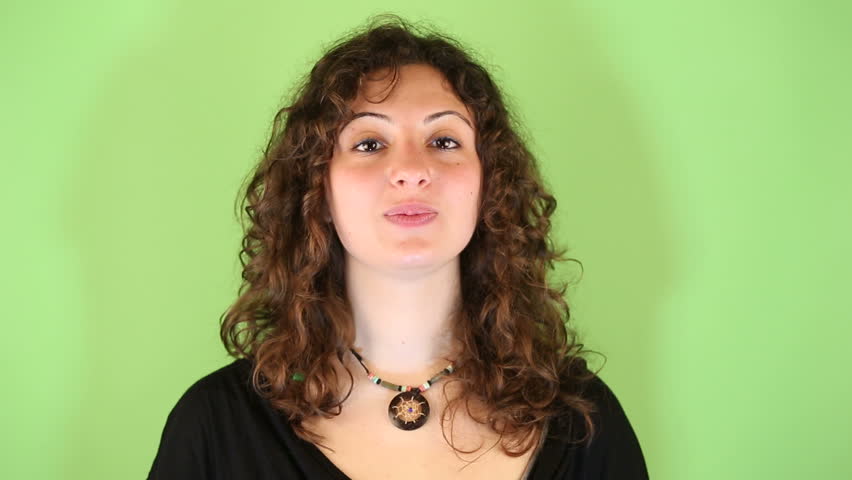 Young Woman Gesturing on Green Background