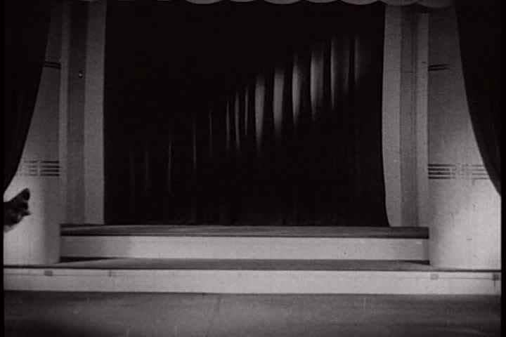 1930s - Silent clowns on stage do gymnastic stunts.