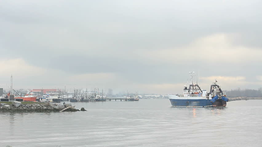 Fishing Dragger, Steveston Harbor. A dragger returning to Steveston from the Georgia Strait on a misty morning. Near Vancouver, British Columbia, Canada.