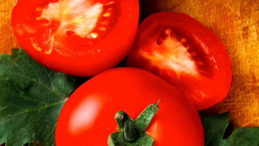 raw vegetables : some uncooked ripe fresh tomatoes over blue table on cutting board 1920x1080 intro motion slow hidef hd