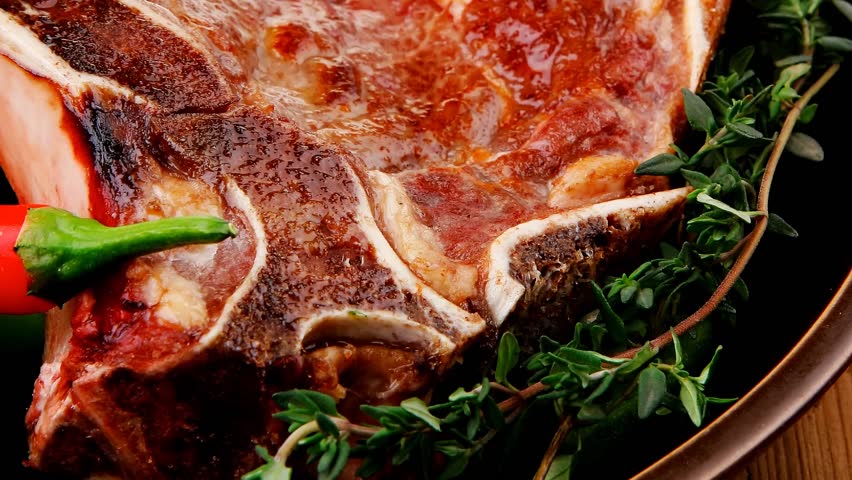 savory : roasted beef spare rib on dark dish with cutlery thyme pepper and tomato on wooden table 1920x1080 intro motion slow hidef hd