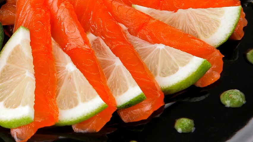 salmon slices and tomatoes on black plate 1920x1080 intro motion slow hidef hd