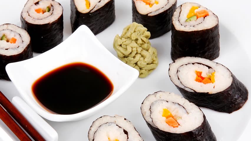 Maki Sushi : Maki Rolls and California rolls made of fresh raw Salmon(sake) Tuna(maguro) and Eel(unagi) . dish with sticks 1920x1080 intro motion slow hidef hd