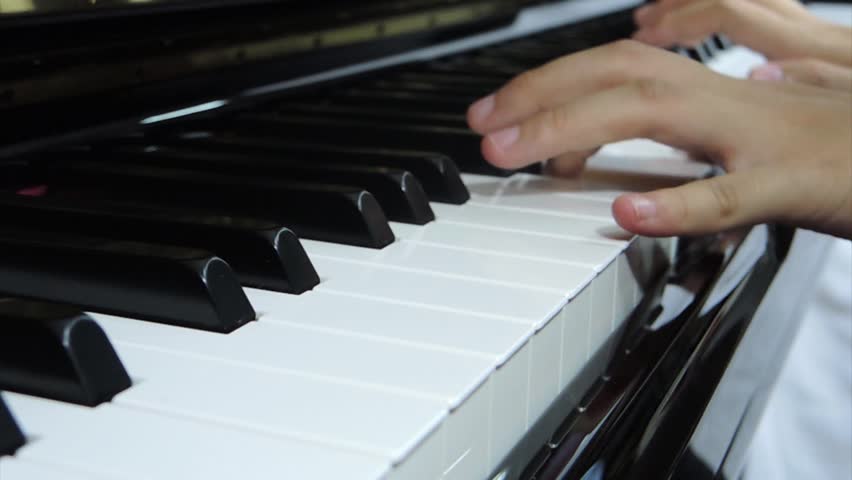closeup hand while playing piano