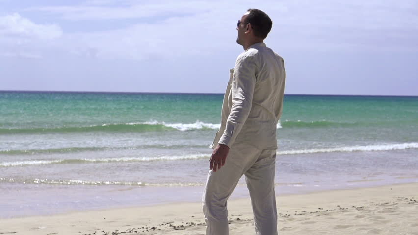 Happy, excited young handsome man relaxing on beach
