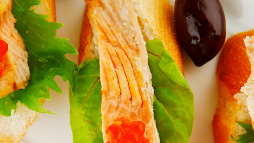 small salmon sandwiches served with caviar and olives 1920x1080 intro motion slow hidef hd