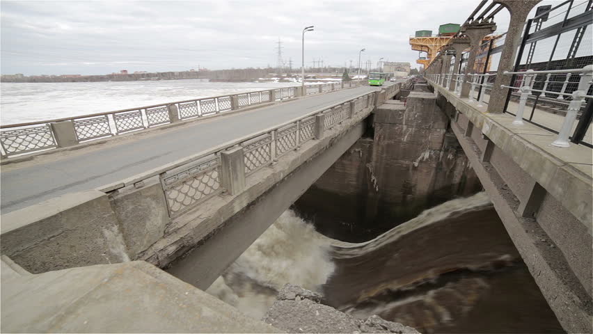 Water running down a dam with opening sluice gates