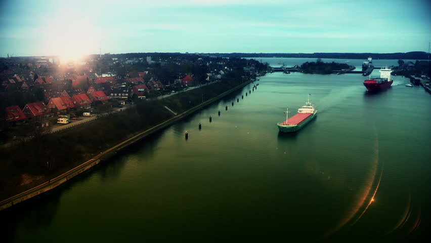 Cargo ships at sunset in Kiel Cannal, Germany, time lapse