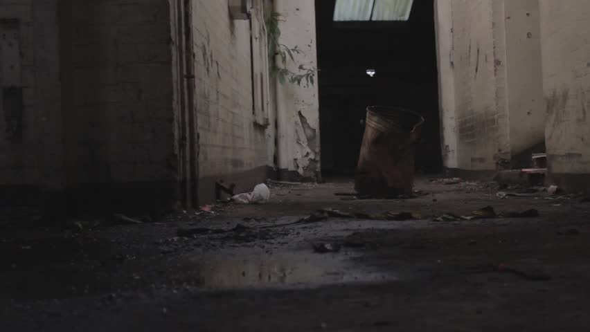 Rusty barrel  in abandoned building (tracking shot)