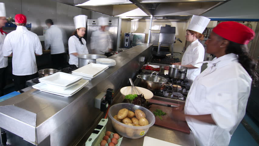 Time lapse clip of a busy team of chefs, working hard and preparing food in a commercial or restaurant kitchen.