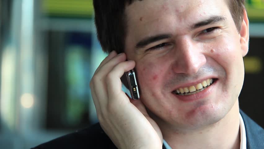 Businessman in business suit speaks on a mobile phone