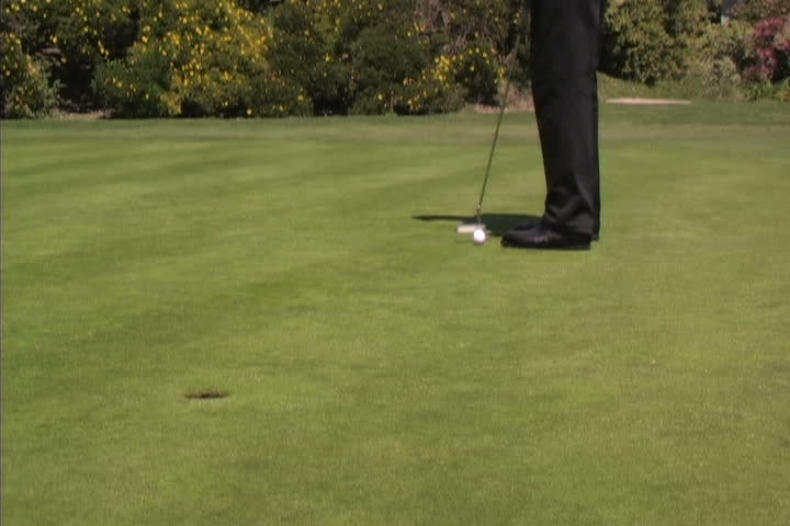 Golfer barely misses a long putt.