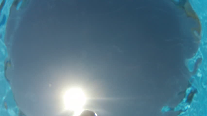 Young boy swimming underwater in sea or pool 