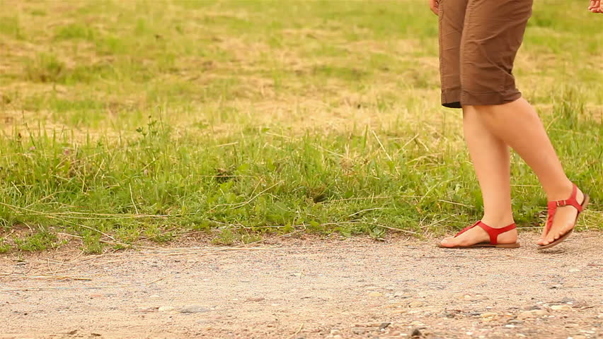 Baby first steps. mother keeps her daughter's hand
