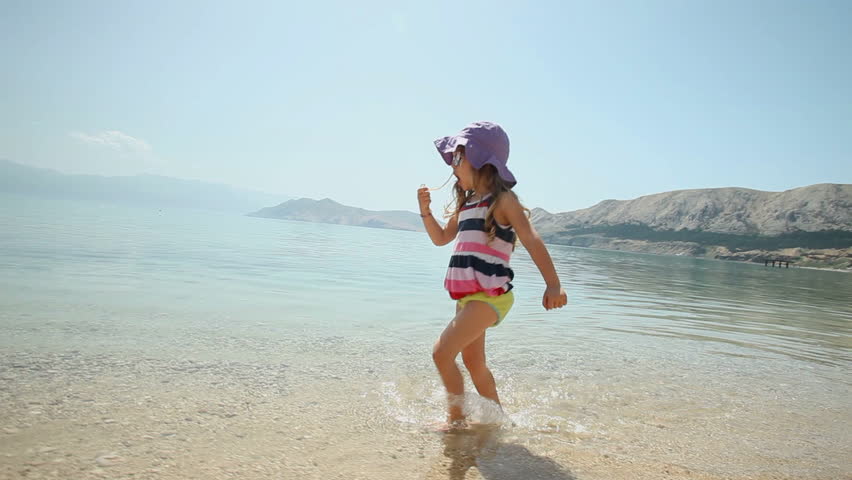 Child playing in the water on beach