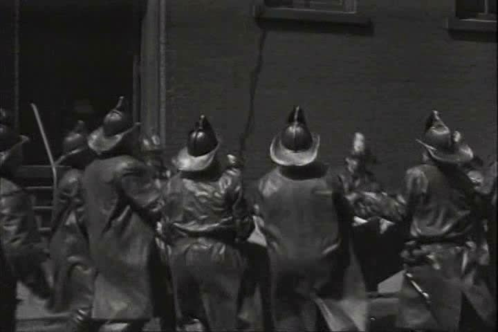 1910s, 1920s - Firemen save a person from a fire who jumps into a net