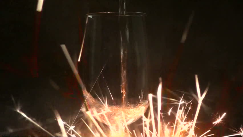 1920x1080 Champagne poured against background of sizzling sparklers.