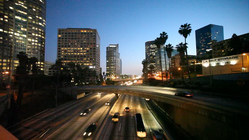 Freeway traffic in downtown Los Angeles at twilight.