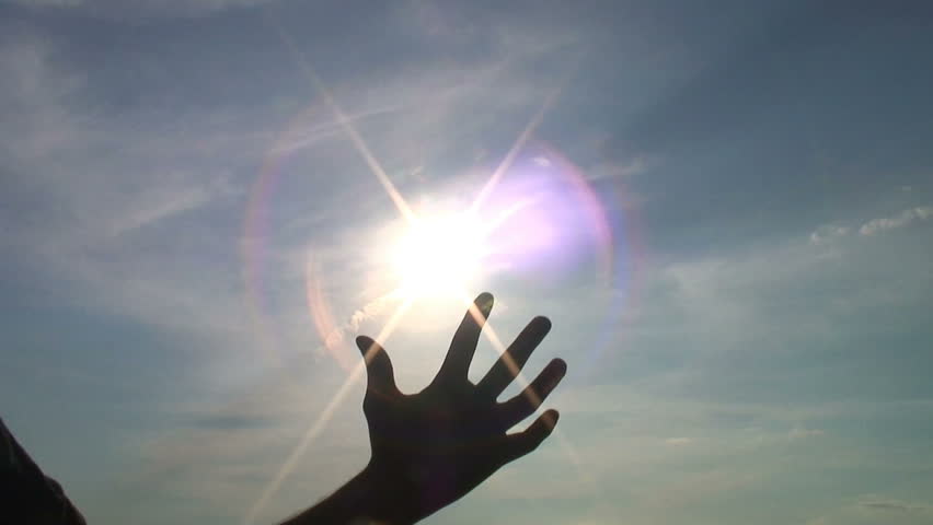 Silhouette of a hand infront of the clear sunny sky. HD 1080
