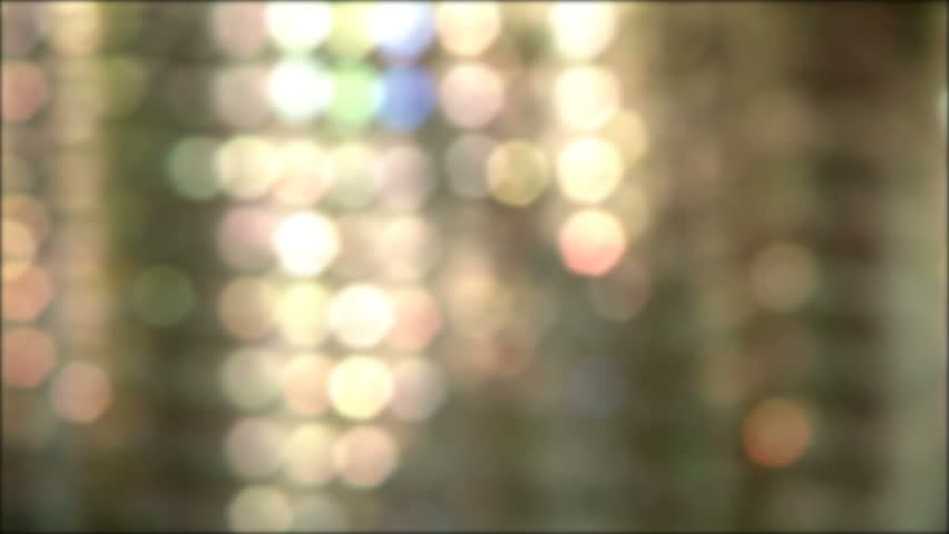Looping soft light reflection background. Layers of blurred light spots moving slowly from left to right. 