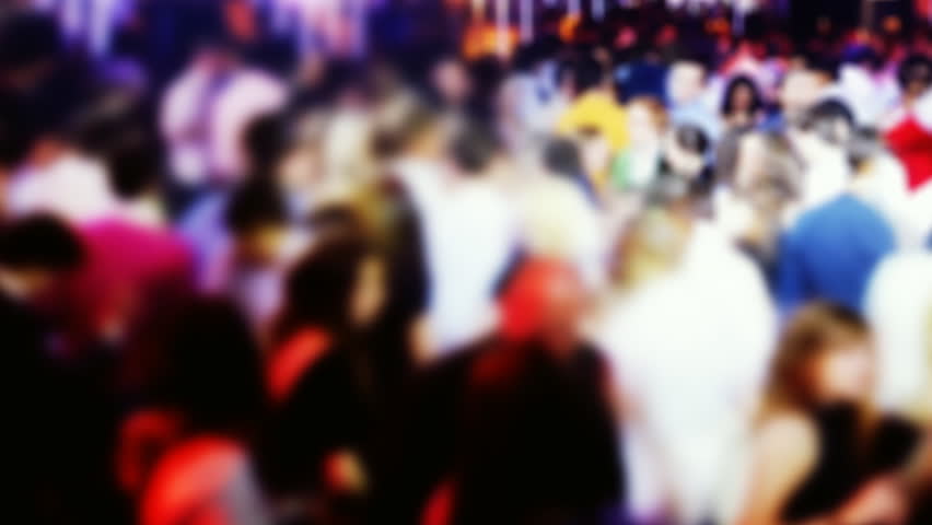 panning across a crowded dance floor in a nightclub. blurred