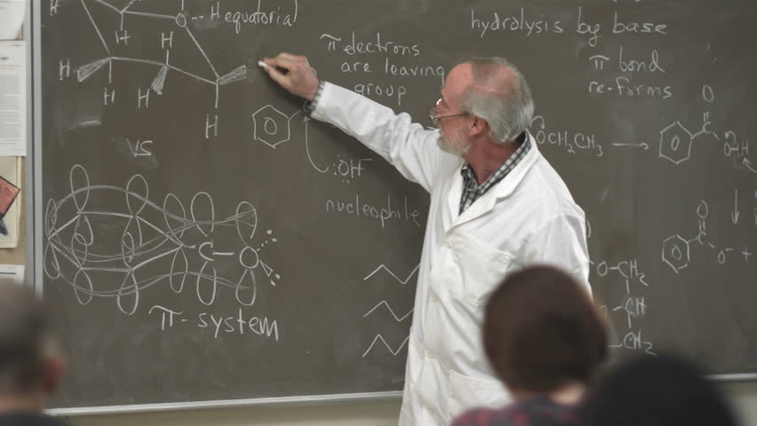 A college professor calls on a student raising their hand in class