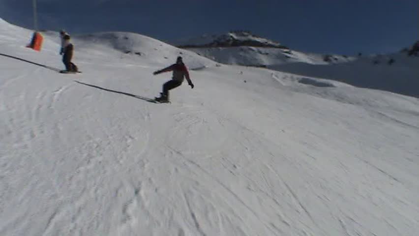 Snowboarder making his way down mountain