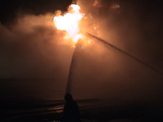 Firefighters have to battle winds and fire while trying to extinguish the fire.