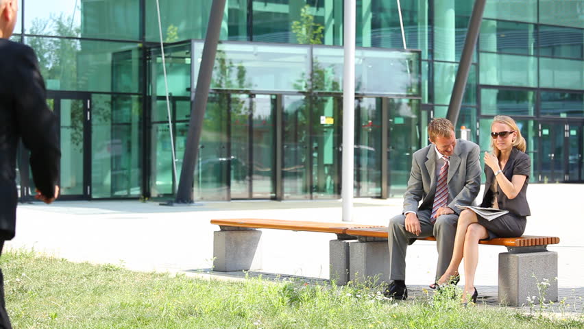 young businessman and woman reading newspaper, senior boss telling them to go to work again