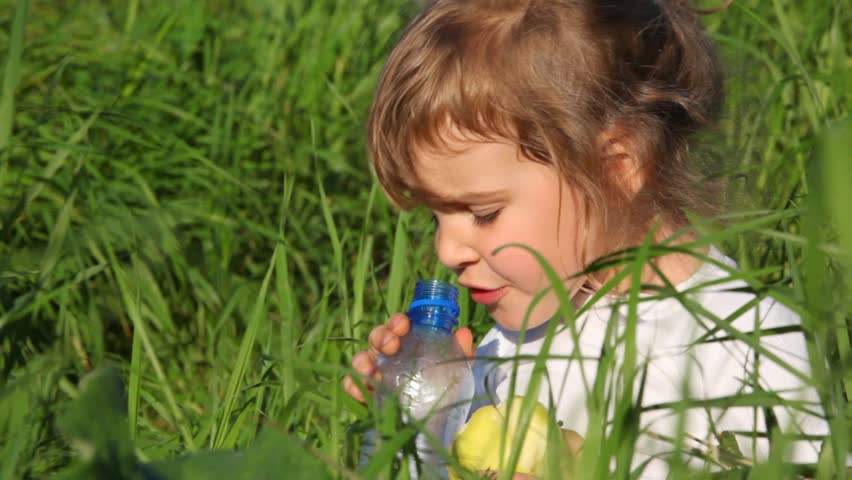 girl drinking water from  bottle close-up 