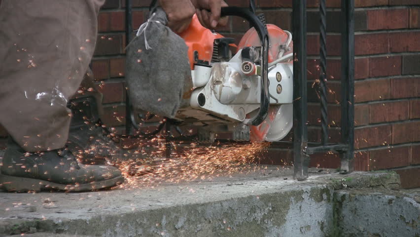 Man uses a circular saw to cut railings. Lots of sparks and good audio. Two shots. 