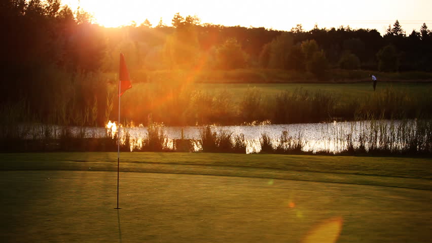 Golf player teeing off on beautiful golf course