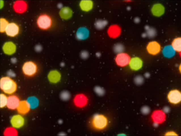 Snow falls in front of colored Christmas lights in this seamless motion loop with a soft focused, ethereal feel. SD