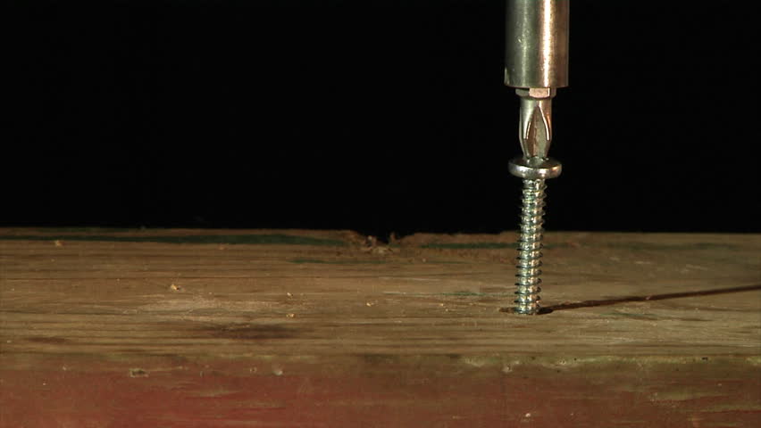 Screwing in a screw.